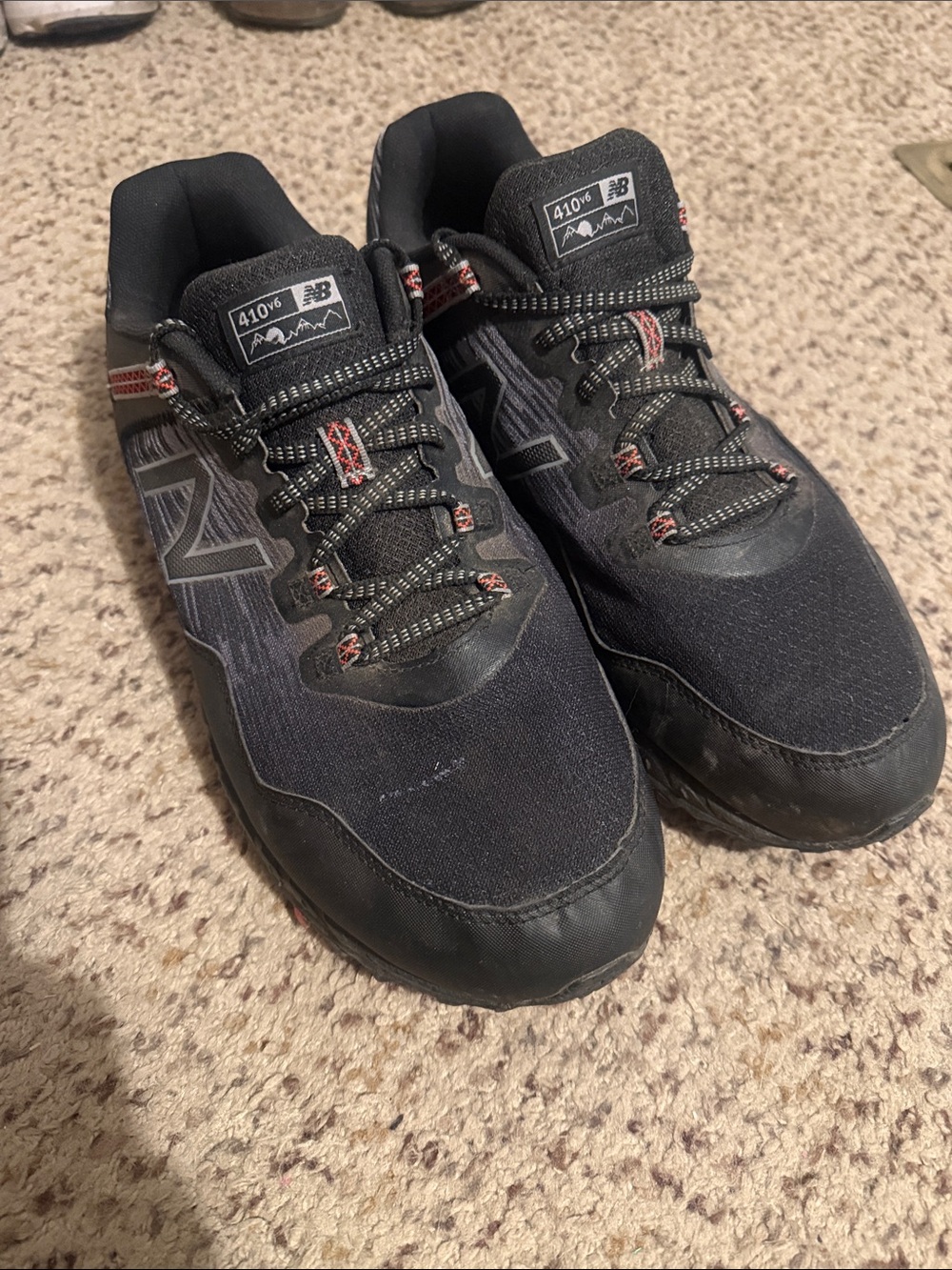 New Balance Men's Black Athletic Trail Shoes with Subtle Red Accents